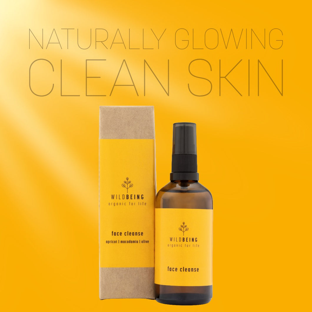 Wildbeing face cleanse bottle and packaging on a yellow background with text 'Naturally Glowing Clean Skin'.
